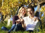 Photo of happy couple sitting in a vineyard in Niagara-on-the-Lake